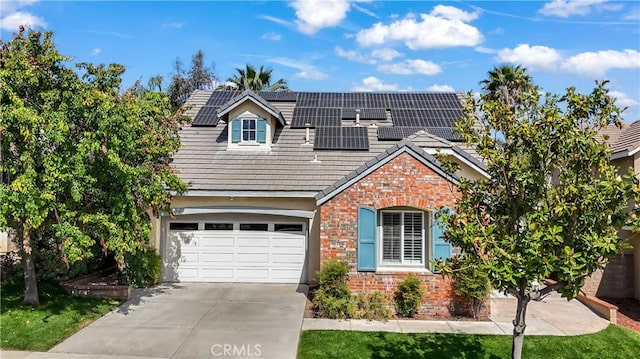 24939 Coral Canyon Rd, Corona, CA 92883 - traditional-style home featuring driveway, brick siding, a garage, and solar panels