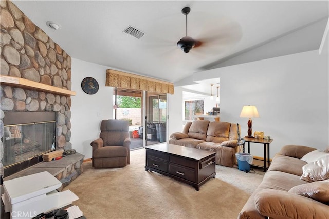 19804 Haida Rd, Apple Valley, CA 92307 - living area with a ceiling fan, a stone fireplace, light colored carpet, visible vents, and vaulted ceiling