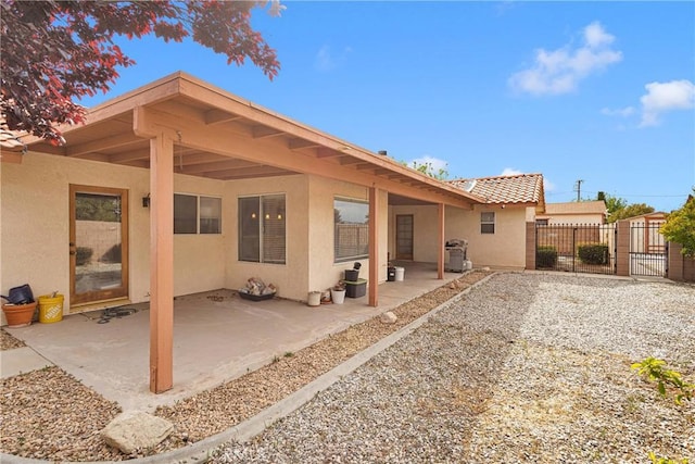 19804 Haida Rd, Apple Valley, CA 92307 - back of house with a gate, a patio area, stucco siding, and fence