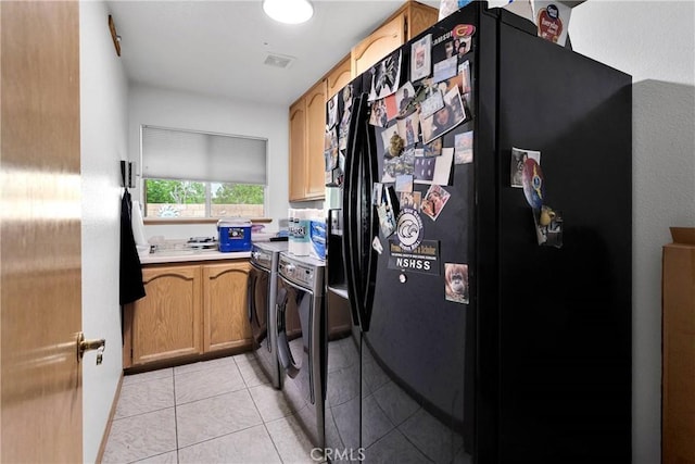19804 Haida Rd, Apple Valley, CA 92307 - kitchen with light tile patterned flooring, light countertops, black refrigerator with ice dispenser, stove, and washing machine and dryer