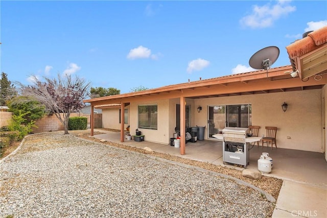 19804 Haida Rd, Apple Valley, CA 92307 - back of property with a fenced backyard, a patio area, and stucco siding