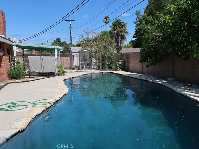 view of pool featuring a storage shed, a fenced in pool, and a fenced backyard
