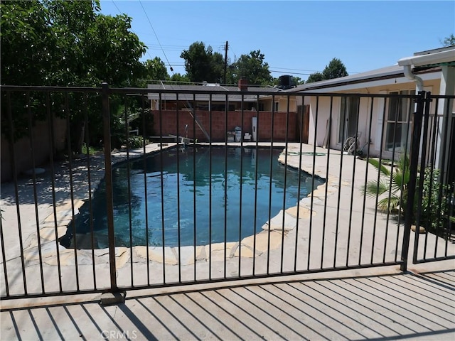 exterior space featuring a fenced in pool, a fenced backyard, and a patio