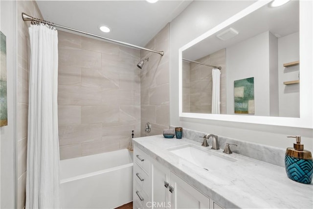 bathroom featuring vanity, recessed lighting, and shower / bathtub combination with curtain