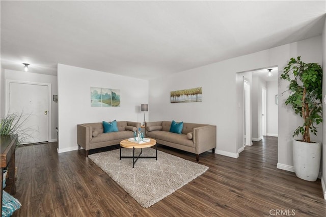 living room with dark wood-style flooring and baseboards