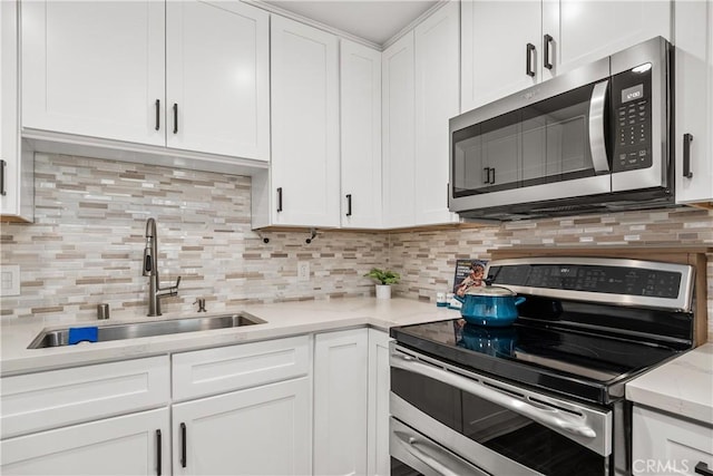 545 Chestnut Ave Unit 202, Long Beach, CA 90802 - kitchen featuring backsplash, stainless steel appliances, white cabinetry, and a sink