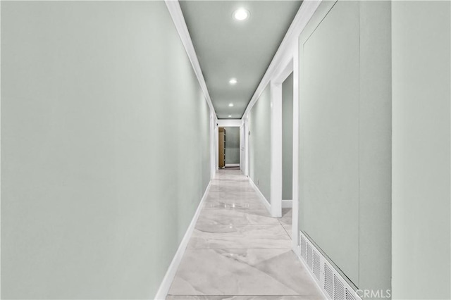 hallway with baseboards, visible vents, recessed lighting, and marble finish floor