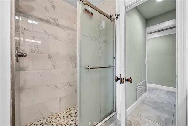 full bathroom featuring visible vents, marble finish floor, baseboards, and a shower stall