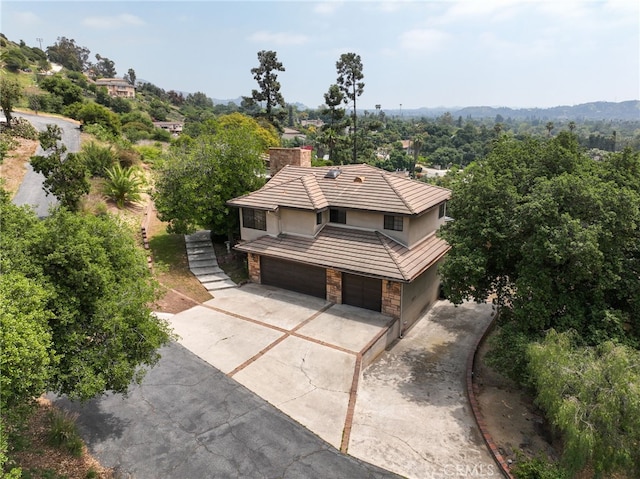 845 N Glendora Ave, Glendora, CA 91741 - exterior space with an attached garage, stone siding, stucco siding, a chimney, and driveway