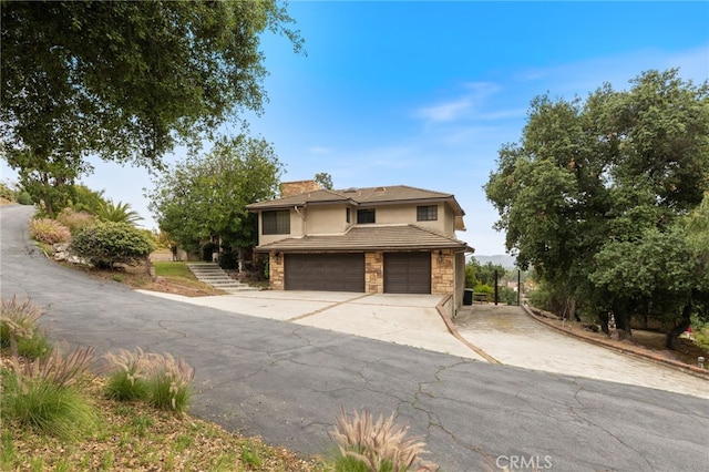 845 N Glendora Ave, Glendora, CA 91741 - view of front of home with driveway, a chimney, a garage, stone siding, and stucco siding