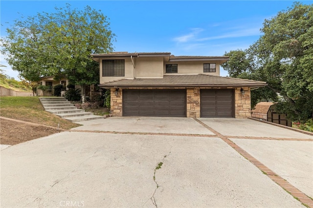 845 N Glendora Ave, Glendora, CA 91741 - view of front facade with an attached garage, stone siding, a tile roof, concrete driveway, and stucco siding