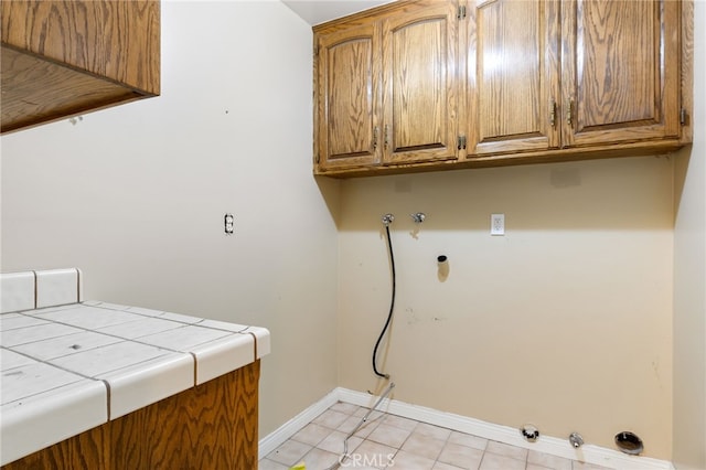 845 N Glendora Ave, Glendora, CA 91741 - washroom featuring cabinet space, hookup for a gas dryer, light tile patterned floors, washer hookup, and baseboards