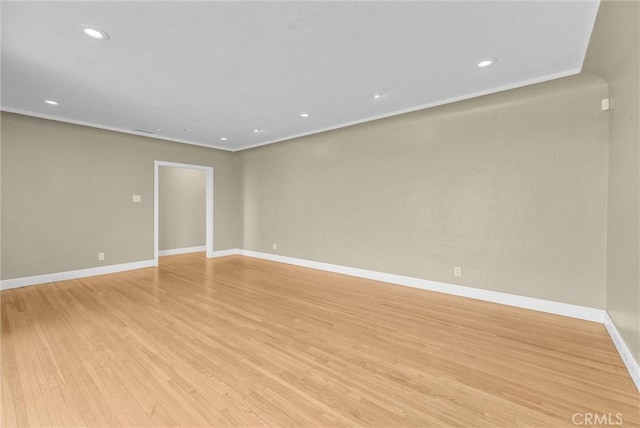 empty room with recessed lighting, baseboards, and light wood-type flooring