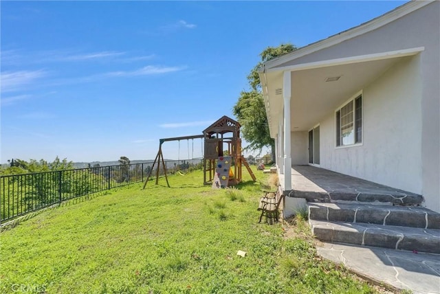 view of yard with a playground and a fenced backyard