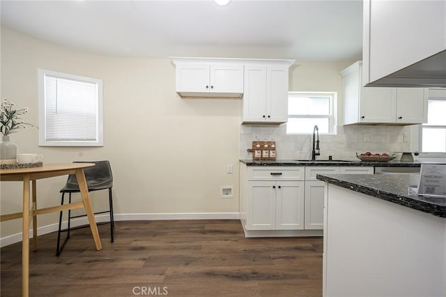 4548 Jade St, Los Angeles, CA 90032 - kitchen featuring backsplash, dark wood finished floors, a sink, dark stone countertops, and white cabinetry