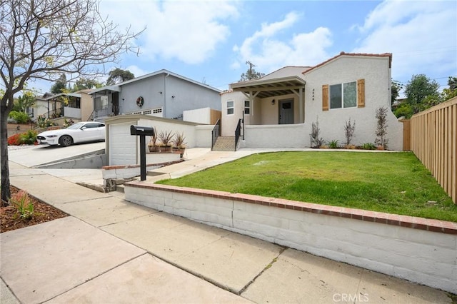 4548 Jade St, Los Angeles, CA 90032 - mediterranean / spanish-style home featuring a front lawn, stucco siding, and fence