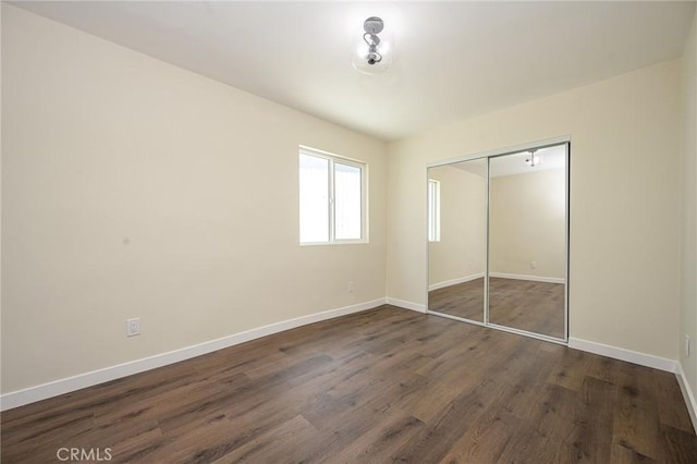 4548 Jade St, Los Angeles, CA 90032 - unfurnished bedroom featuring baseboards, dark wood-style floors, and a closet