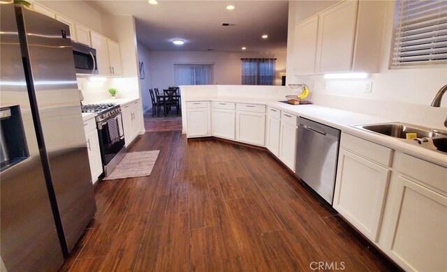 7353 W Ellena W Unit 83, Rancho Cucamonga, CA 91730 - kitchen featuring appliances with stainless steel finishes, white cabinets, light countertops, dark wood-style flooring, and recessed lighting