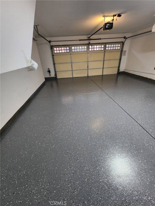 7353 W Ellena W Unit 83, Rancho Cucamonga, CA 91730 - garage with a garage door opener and baseboards