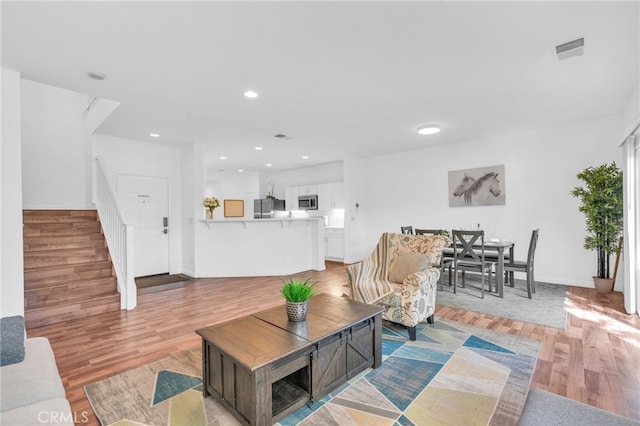 7353 W Ellena W Unit 83, Rancho Cucamonga, CA 91730 - living room with stairs, light wood finished floors, recessed lighting, and baseboards