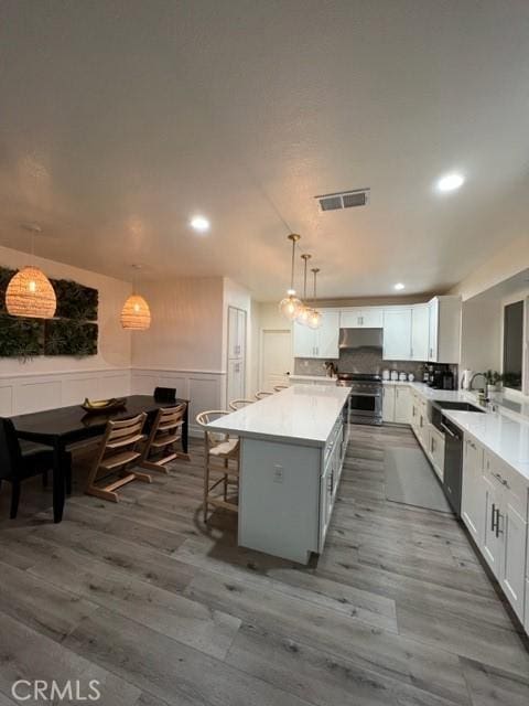 27041 S Ridge Dr, Mission Viejo, CA 92692 - kitchen with electric stove, recessed lighting, dark wood-type flooring, dishwashing machine, and a center island