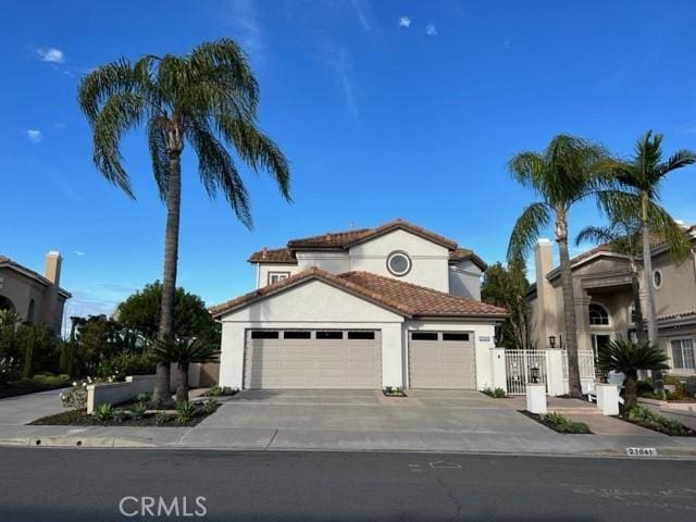 27041 S Ridge Dr, Mission Viejo, CA 92692 - mediterranean / spanish home with a garage, driveway, stucco siding, and a tiled roof