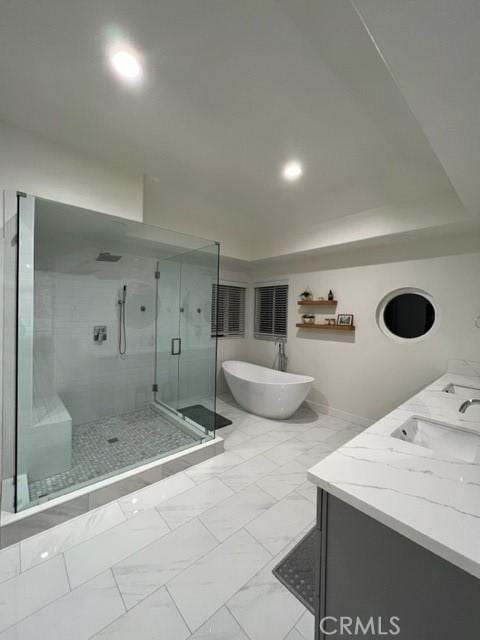 27041 S Ridge Dr, Mission Viejo, CA 92692 - bathroom with a shower stall, a freestanding bath, double vanity, marble look tiles, and recessed lighting