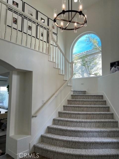 27041 S Ridge Dr, Mission Viejo, CA 92692 - staircase featuring a chandelier and a high ceiling