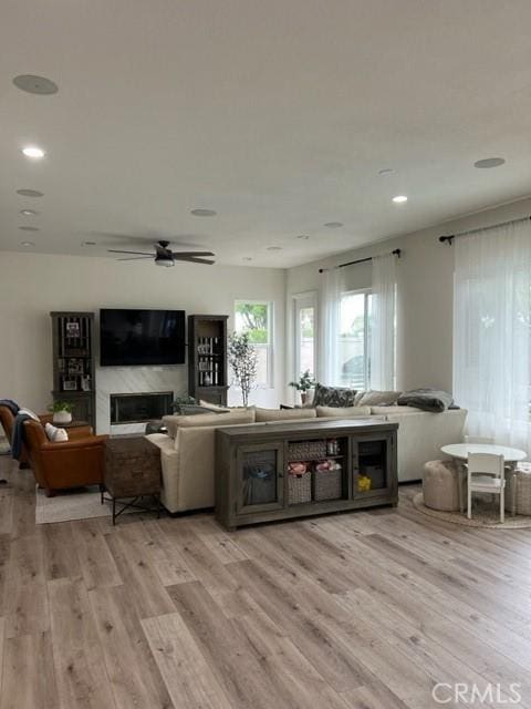 27041 S Ridge Dr, Mission Viejo, CA 92692 - living room with light wood-style flooring, a ceiling fan, a fireplace, and recessed lighting