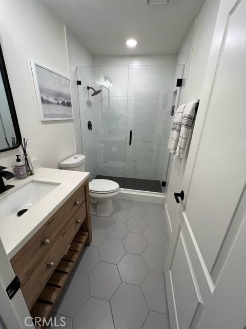 27041 S Ridge Dr, Mission Viejo, CA 92692 - bathroom with vanity, a shower stall, tile patterned flooring, and recessed lighting