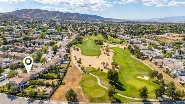 aerial view with view of golf course, a mountain view, and a residential view