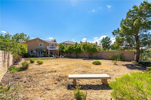 view of yard with french doors and a fenced backyard