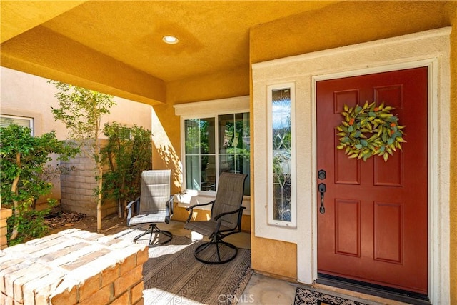 property entrance with stucco siding