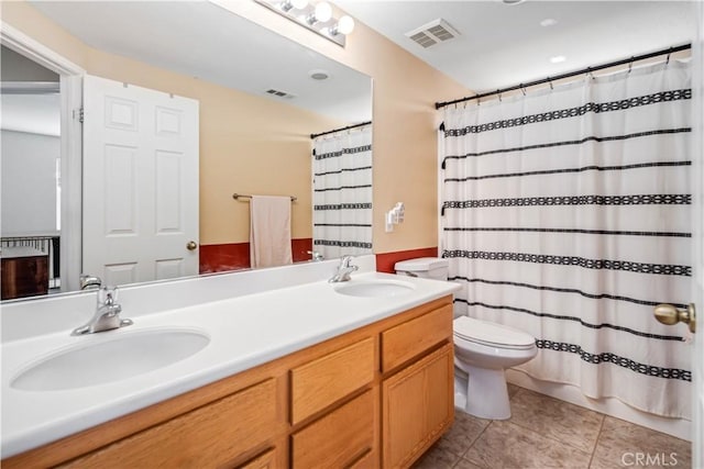 full bathroom featuring toilet, tile patterned floors, visible vents, and a sink