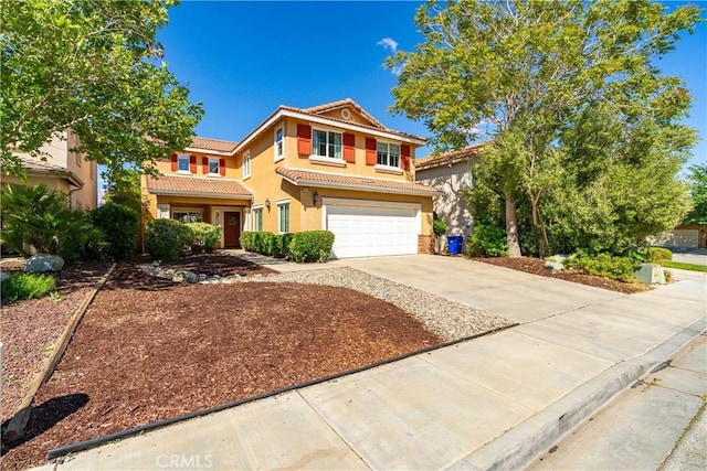 view of front of home featuring a garage, stucco siding, a tiled roof, and concrete driveway