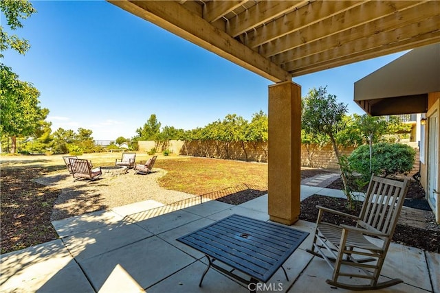view of patio with a fenced backyard and an outdoor fire pit