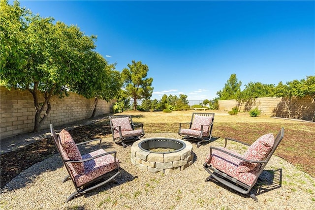 view of yard with a fire pit and a fenced backyard
