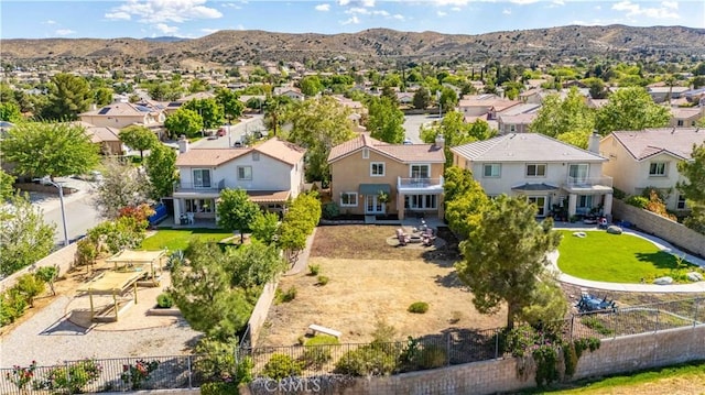 drone / aerial view featuring a residential view and a mountain view