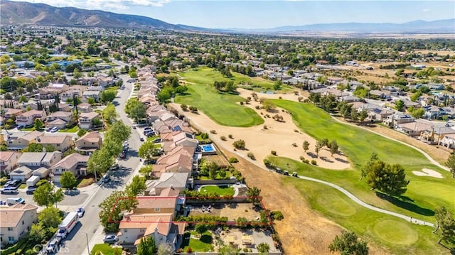 aerial view with a residential view, a mountain view, and golf course view