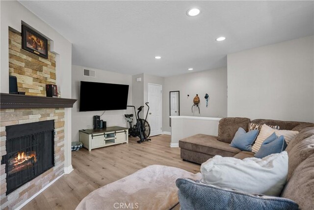 18114 Erik Ct Unit 5131, Canyon Country, CA 91387 - living area featuring light wood-style floors, a stone fireplace, baseboards, and recessed lighting