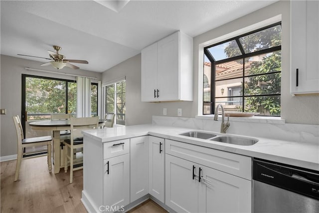 18114 Erik Ct Unit 5131, Canyon Country, CA 91387 - kitchen featuring stainless steel dishwasher, a sink, white cabinetry, light wood-type flooring, and light stone countertops