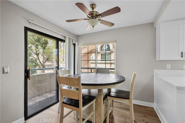 18114 Erik Ct Unit 5131, Canyon Country, CA 91387 - dining area with baseboards, light wood-style flooring, and a ceiling fan