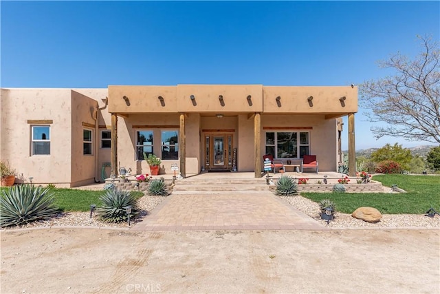 35155 Sawh Ct, Sage, CA 92544 - rear view of property featuring covered porch, stucco siding, and a yard
