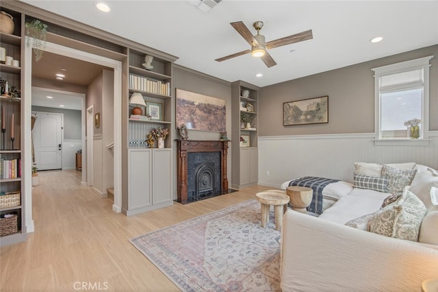 18147 Jupiter Ln, Saugus, CA 91350 - living room with ceiling fan, light wood finished floors, wainscoting, a fireplace with flush hearth, and recessed lighting