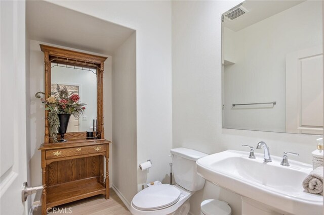 18147 Jupiter Ln, Saugus, CA 91350 - bathroom featuring a sink, toilet, and wood finished floors