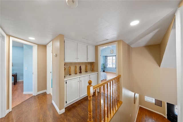 45628 Gleneagles Ct, Temecula, CA 92592 - hall with recessed lighting, baseboards, an upstairs landing, and dark wood finished floors