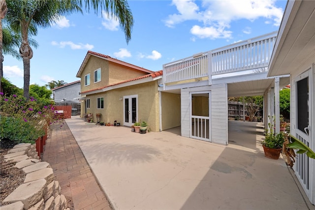 45628 Gleneagles Ct, Temecula, CA 92592 - exterior space with fence, stucco siding, a patio area, and french doors