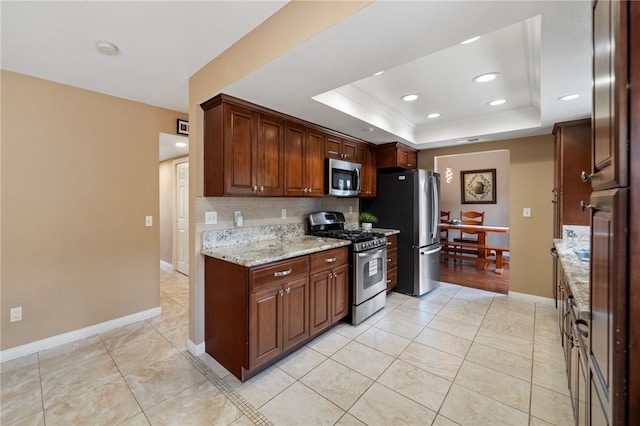 45628 Gleneagles Ct, Temecula, CA 92592 - kitchen with light stone countertops, light tile patterned floors, a tray ceiling, appliances with stainless steel finishes, and backsplash