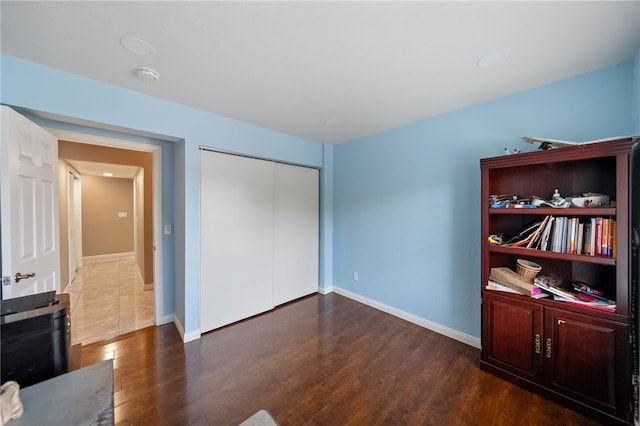 45628 Gleneagles Ct, Temecula, CA 92592 - unfurnished bedroom with baseboards, a closet, and wood finished floors