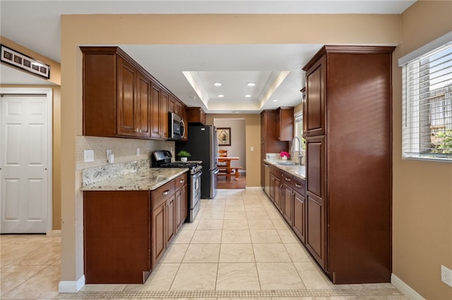 45628 Gleneagles Ct, Temecula, CA 92592 - kitchen with light tile patterned flooring, a sink, stainless steel appliances, baseboards, and tasteful backsplash